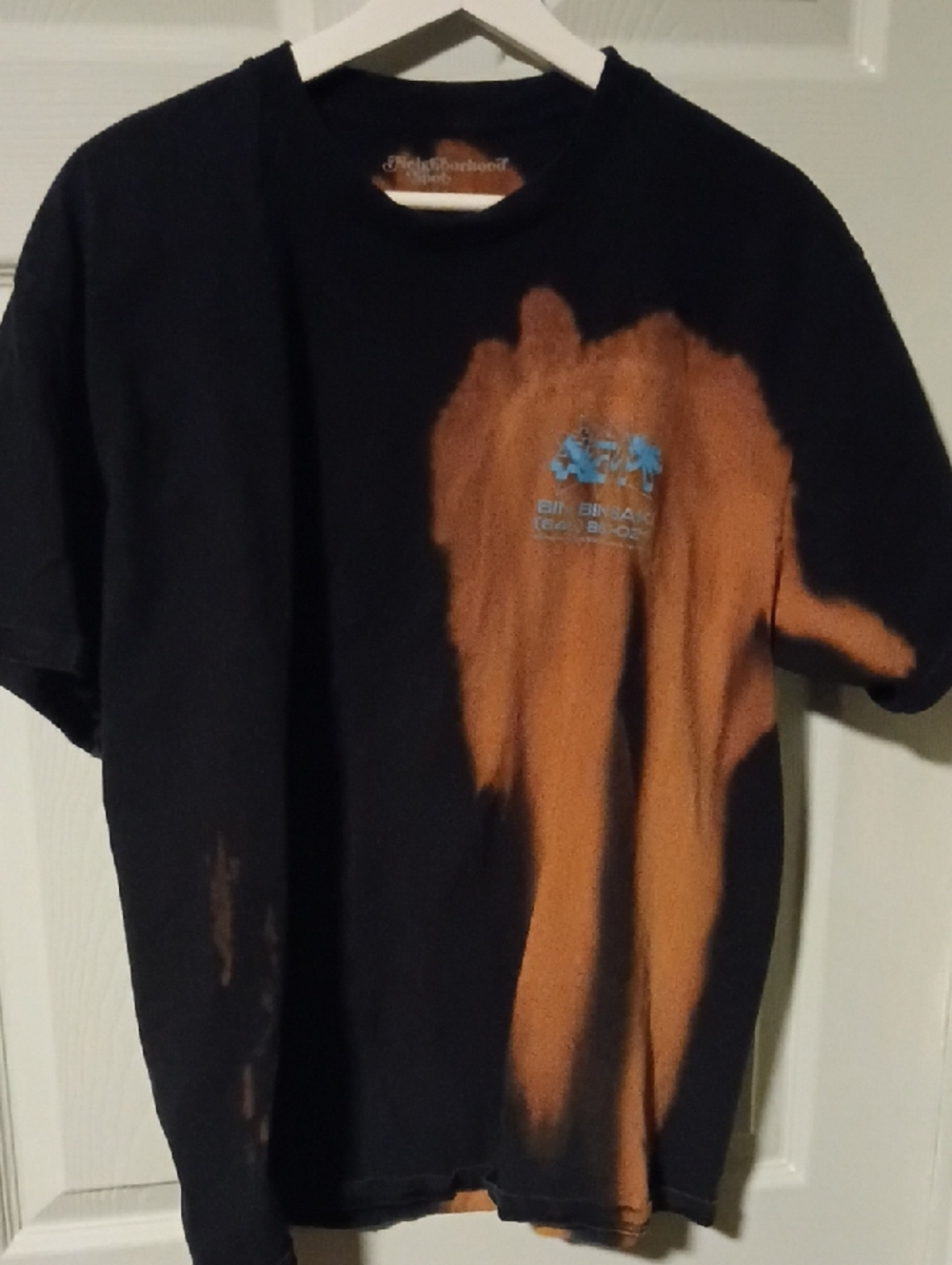Neighborhood Black Tee with Orange Bleach Effect and Silver Logo